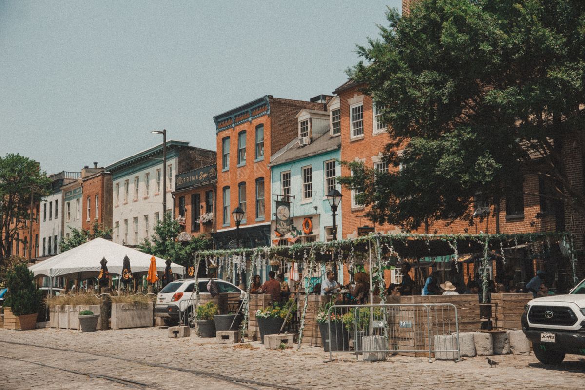 Colorful Baltimore rowhouses on a cobblestone block